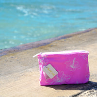 Pink Hibiscus Accessory Bag on the beach