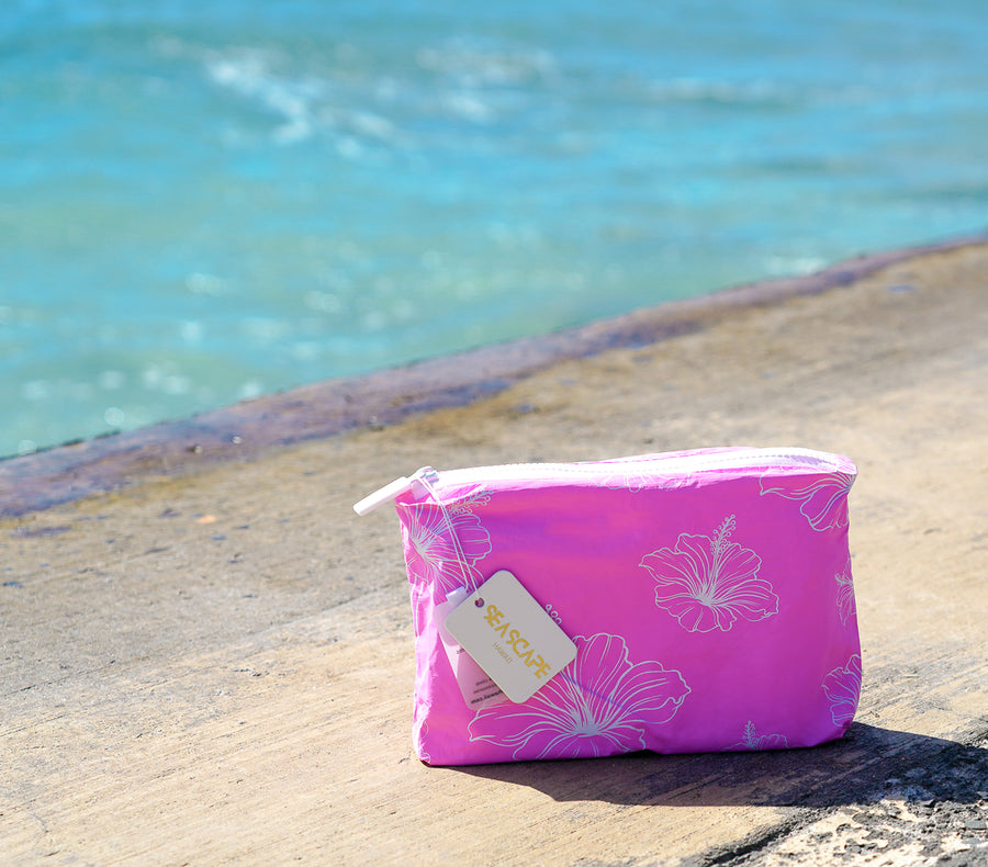 Pink Hibiscus Accessory Bag on the beach